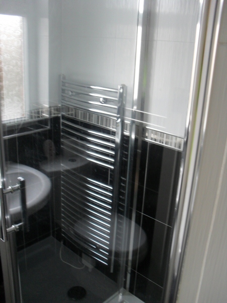 Photo - Contemporary Bathroom (2 of 3) - View through shower unit of chrome heated towel rail. - Fitted Kitchens and Bathrooms - Home - © J C Joinery