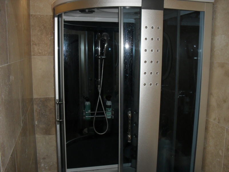 Photo - Ensuite Bathroom (1 of 1) - Fitted with Aqua Plus steam shower with integrated radio and telephone, travertine marble tiling and UPVC ceiling with decorative chrome inlay, for a customer in Blackpool. - Fitted Kitchens and Bathrooms - Home - © J C Joinery