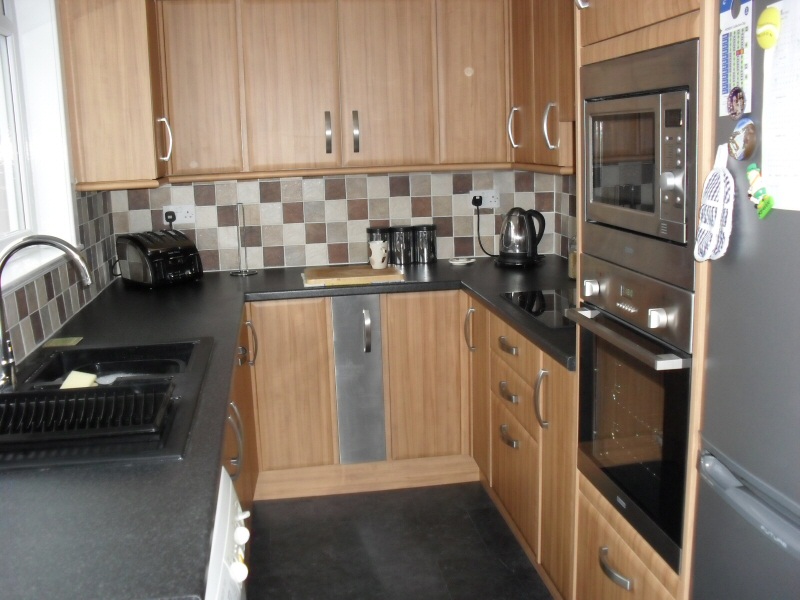 Photo - Kitchen Before and After (2 of 6) - New fitted kitchen with units, tiling, flooring, electrics and fitted appliances including cooker and microwave. - Property Refurbishment - Home - © J C Joinery