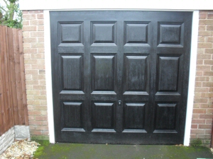 Photo - Georgian style matt black automatic up and over GRP garage door with wood grain effect