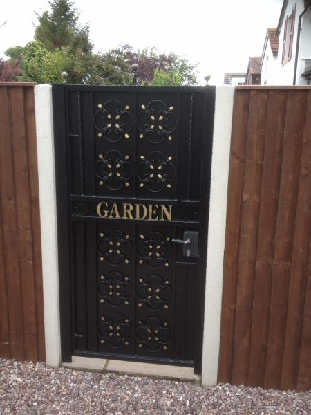 Photo - Gate, Fence and Railings (1 of 2) - Wooden fence with concrete support posts and lockable secure wrought iron gate to prevent access to the rear of the property. - Other Joinery and Building Work - Home - © J C Joinery